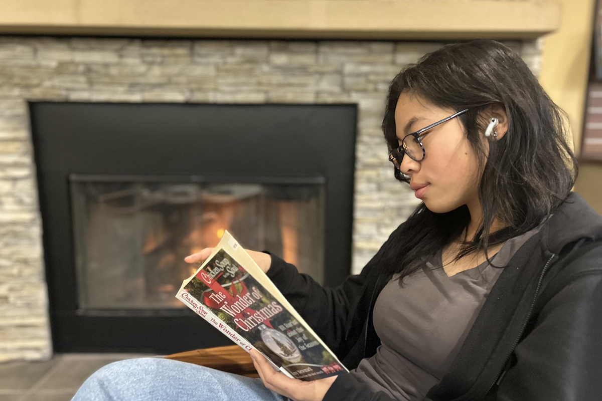 Carlmont sophomore Dakota Chang listens to Matthew Ifield’s new Christmas album while reading her favorite book to de-stress before studying. Besides holiday music, many other aspects of the holidays invoke the holiday spirit. “Since decorations are Christmas themed, it allows those who see them to realize that the holidays are coming. They get excited and realize there will be a time for them to take a break from the regular chaos of their lives as they relax and spend time with their families,” Chang said.