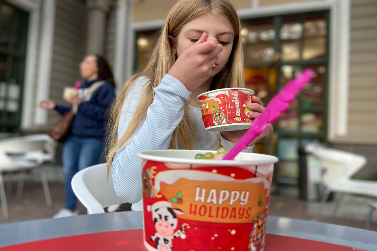 Addison Miller snacks on her custom creation at Menchie's, where topping choices turned dessert into a personalized experience.