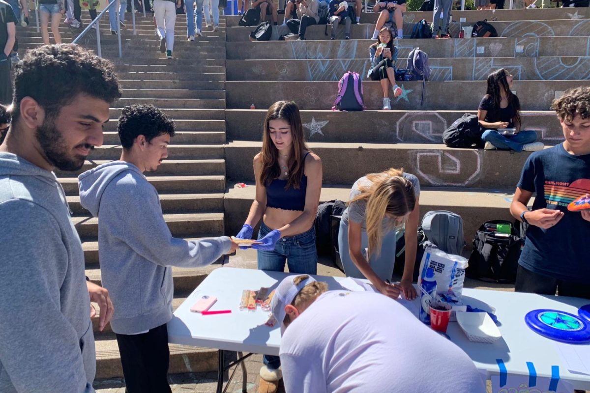 French Club leaders serve students crepes in the quad. "During the club fair, we had a crepe station where people go to decorate their crepes," Skaf said. 
