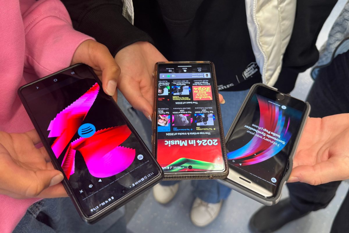 Students showcase their 2024 Spotify Wrapped, comparing vibrant visuals and personalized summaries. This year’s AI-driven features sparked mixed reactions, fueling conversations about music trends and listening habits.