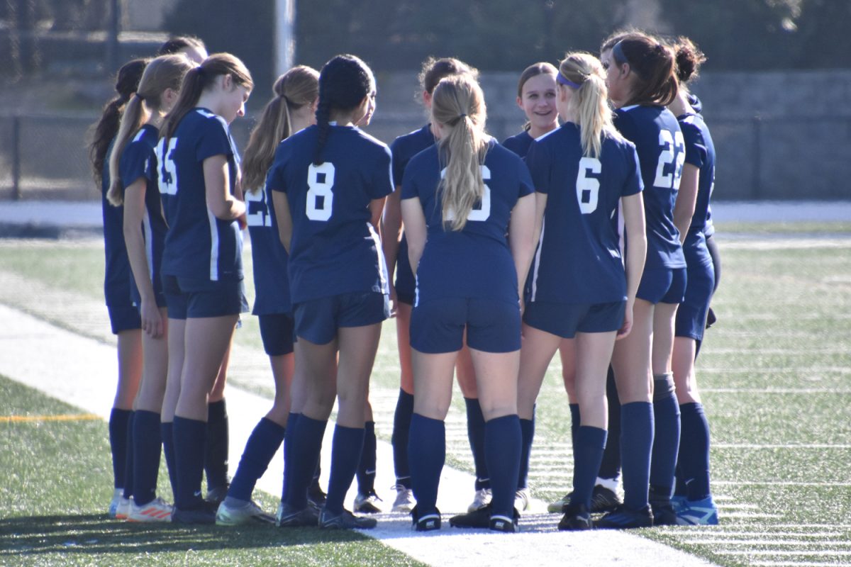 Carlmont's freshman girls' soccer team huddles up in preparation for a big game. "We work well together as a team. We all feel confident in each other and are there to support each other when needed," said Callie Hernandez, the girl's freshman team captain. 