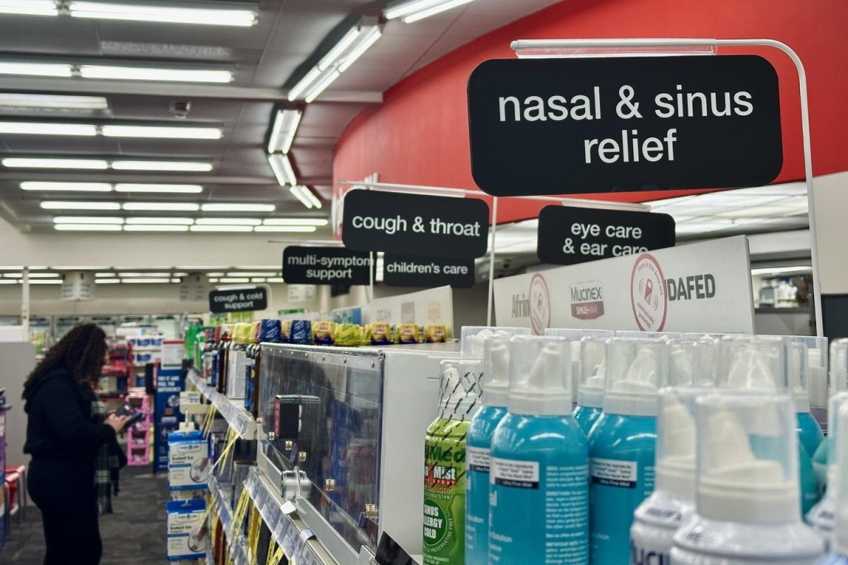 Shoppers browse the aisles of a pharmacy. Americans often turn to local pharmacies for decongestants, cough suppressants, antihistamines, expectorants and other medications to help deal with respiratory illnesses.