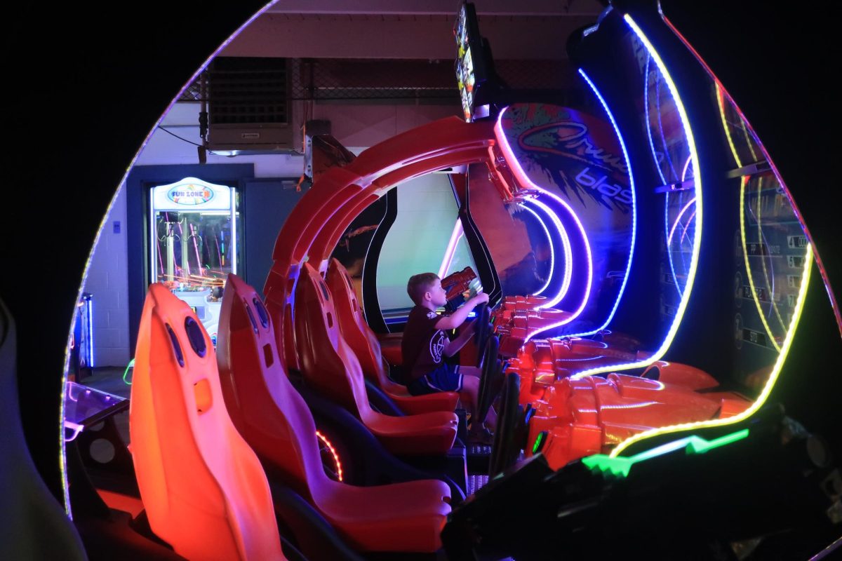 A young boy plays a racing simulator at Redwood City's pop-up arcade, the Parcade. 