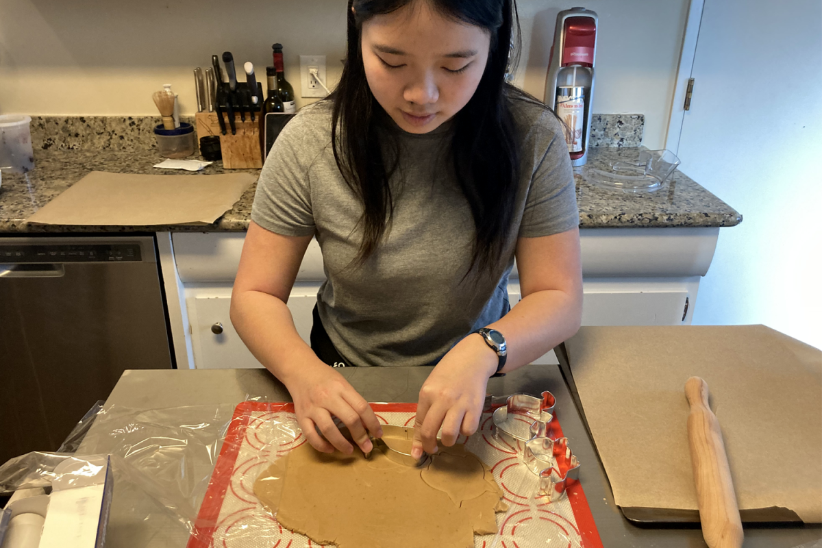 Jasmine Lee, a sophomore, cuts cookies in her homemade dough. She made plans with a friend after they chose not to attend winter formal. "I just don't find it that amusing to go stand, listen to loud music, and jump for hours," Lee said.