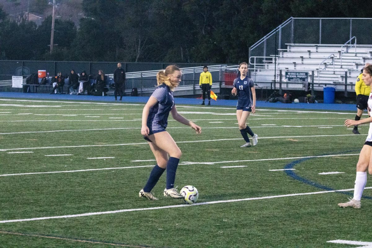 Carlmont sophomore Nicole Franklin dribbles up towards the defender. The ball is kept close to ensure it's not lost. This allowed Franklin to keep the ball safe and advance further up.