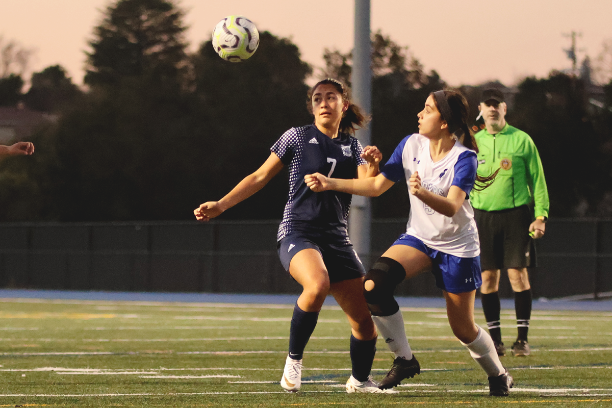 Junior Anna Jaya Motamarry tracks the ball as she prepares to trap it from the air. Trapping is a fundamental soccer skill that allows players to maintain possession of the ball. Players must make a good first touch when trapping the ball to set up their next move accurately.