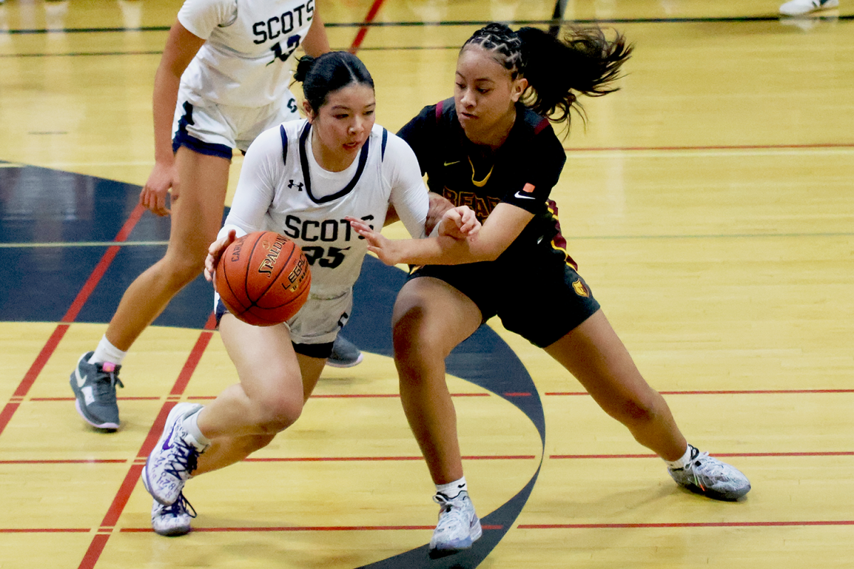 Ishibashi-To attempts to dribble past her defender in hopes of getting a breakaway. Before the play, Ishibashi-To stole the ball from behind the Menlo-Atherton player. The audience broke into cheers at the excitement of this play. 