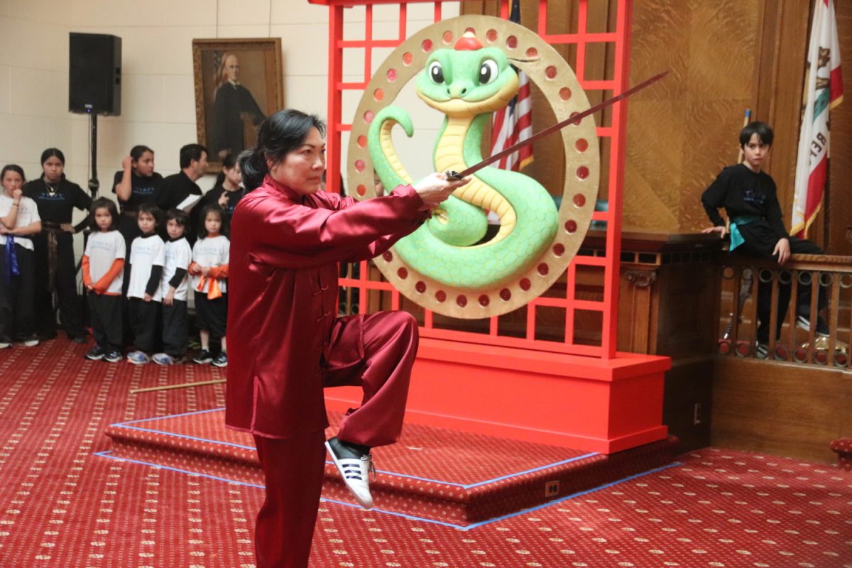 Karen Singer, from the California Kung Fu and Tai Chi Institute, performs Tai Chi with an imitation sword. The demonstration sport has evolved from a form of self-defense to a form of art that has been popularized among adults. “Our students perform with more ‘dangerous’ weaponry while us, adults, perform Tai Chi and only sometimes utilize weapons,” Singer said. 