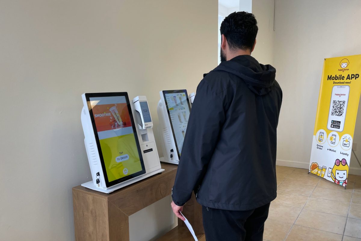 A customer orders a drink through Happy Lemon’s kiosk. Bubble tea stores have begun to transition to online ordering rather than having employees take orders. “Part of my job is taking orders to the front of the store. However, a lot of people use the kiosks now, so I don't do much of that,” said Suri Taherian, a Carlmont sophomore and Happy Lemon employee