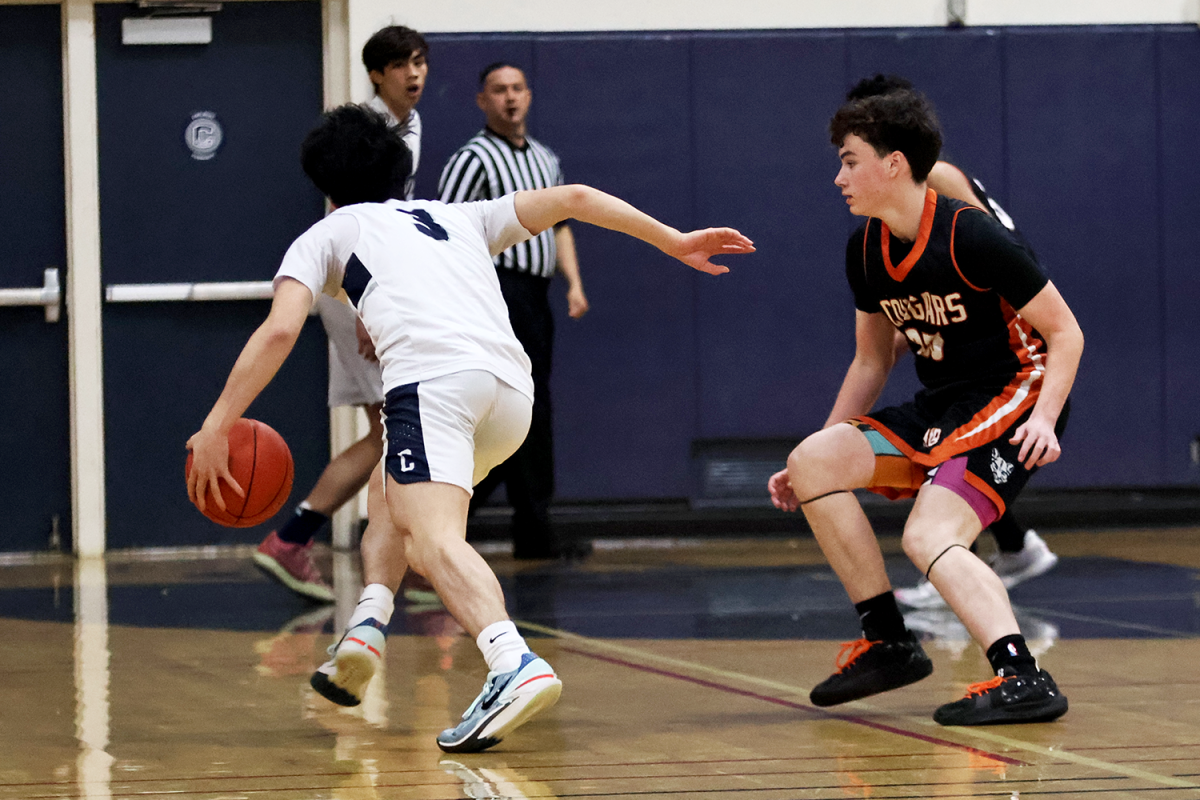 Senior Camden Ngo drives down the left side of the court as he breaks away from his defender. Following this drive, Ngo sunk a three-point shot. This gave the Scots a strong start to the game and upped the enthusiasm in the crowd. 