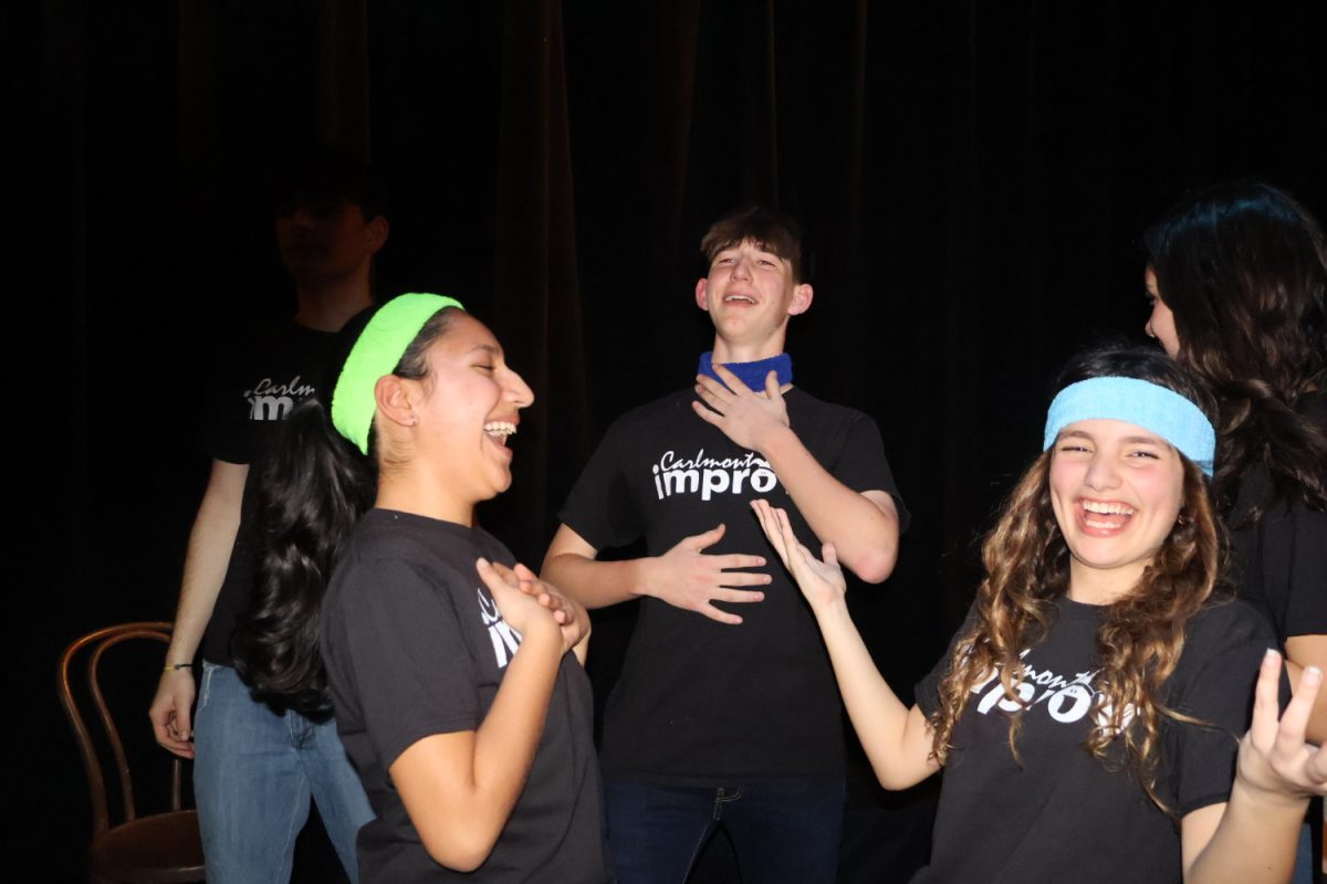 Asha Mehta, Ryan Evert, and Mia Judkins laugh together. They are members of the Carlmont Improv Team.