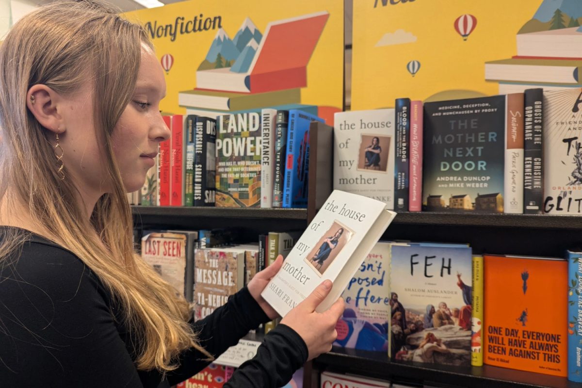 A customer looks at a book titled "The House of My Mother." This memoir delves into the experiences of Shari Franke and the abuse she and her siblings faced at the hands of their mother, Ruby Franke. While their life appeared ideal in many ways on their YouTube channel, there was much worse occurring behind the scenes.