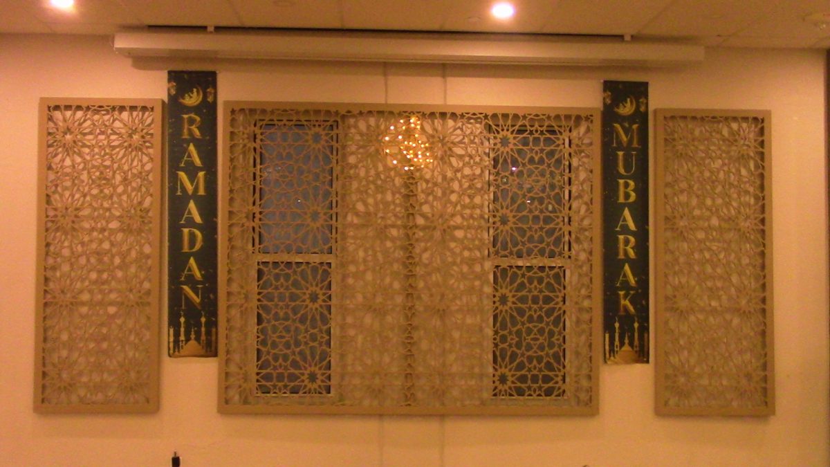 This is a banner in the mosque that says "Ramadan Mubarak". The phrase "Ramadan Mubarak" is the equivalent of saying "Happy Ramadan". Decorations like these get people in the mood of the month.