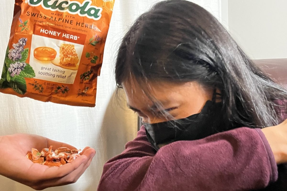 Student coughs next to a bag of cough drops. While not a permanent solution, they can help ease the pain of various symptoms, the most prominent being sore throats.