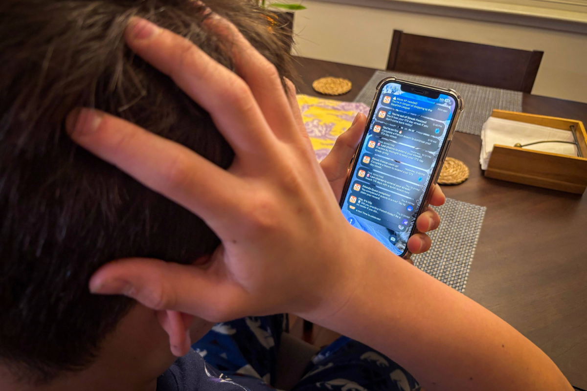 A boy checks his phone, only to be overwhelmed by a flood of Duolingo notifications. Millions of users can relate to his experience — trapped in the app’s gamified system and unable to escape its addictive pull.