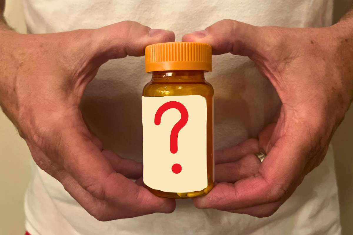 A person holds up a plain white pill bottle marked with a bold question mark, representing the uncertainty of compounded weight-loss drugs. According to the U.S. Food and Drug Administration, compounded drugs should only be used when no FDA-approved option exists, as poor compounding practices can cause contamination or incorrect dosages, posing serious health risks such as injury or death.