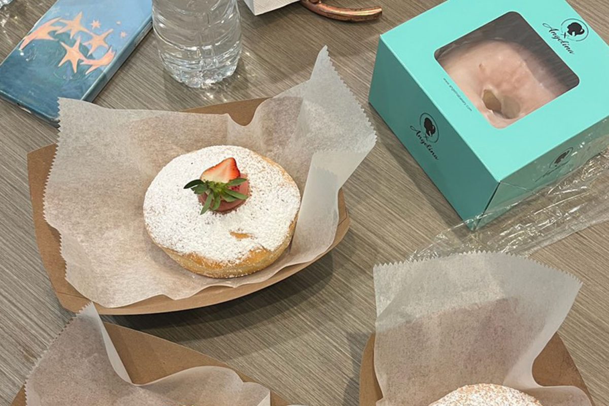 Senior Kimberly Garcia Cancio takes a picture of her strawberry bomboloni at Angelina Bakery. "I was scared it was going to taste like artificial strawberry, but it didn't at all," said Garcia Cancio