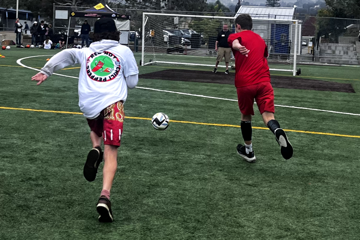 Players run to score a goal in a friendly scrimmage against the volunteers. Each session concludes with a friendly scrimmage. This season the players, known as the Red Hot Chili Peppers, are undefeated. “It’s a really good event,” said Tyen Pham, a caretaker of one of the players. “It’s benefiting all the kids here, and it’s fun.” 