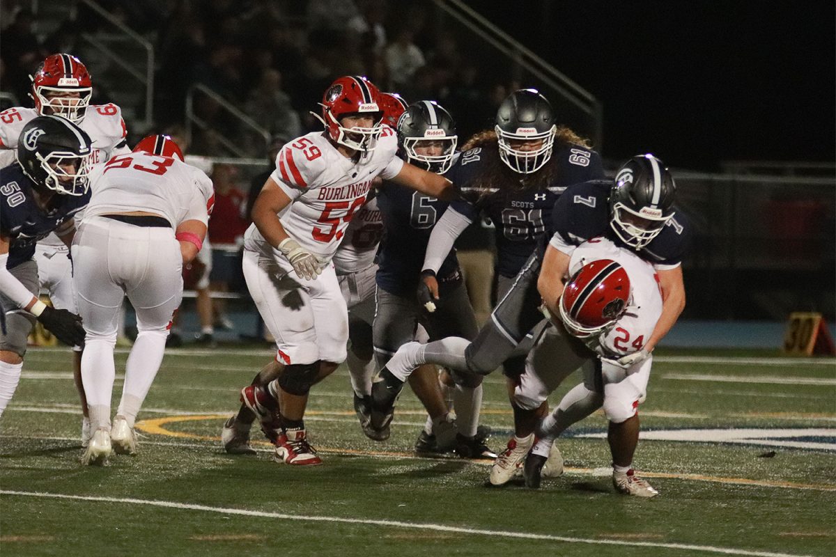 Senior tight end Derek Anderson tackles a Panthers player after an interception. Successfully brining him down, Anderson prevented the Panthers from gaining any additional yards. The Scots threw multiple interceptions throughout the game, leading to turnovers in favor of the Panthers.