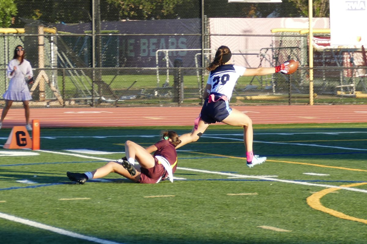 The Scots scored a touchdown by running the ball down the field and through the end zone. A Menlo-Atherton player tried to pull her flags. Since the Carlmont player escaped without being deflagged, the touchdown is viable.