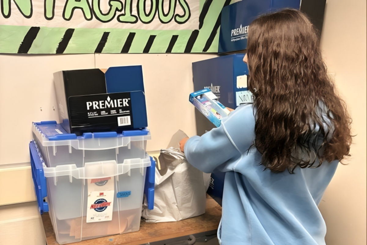 Callie Hernandez, a sophomore at Carlmont High School, adds her contribution to the steadily expanding pile of goods in the Assembled Student Body (ASB) classroom. Her help allowed ASB to work toward its goal of supporting the extended Carlmont community.