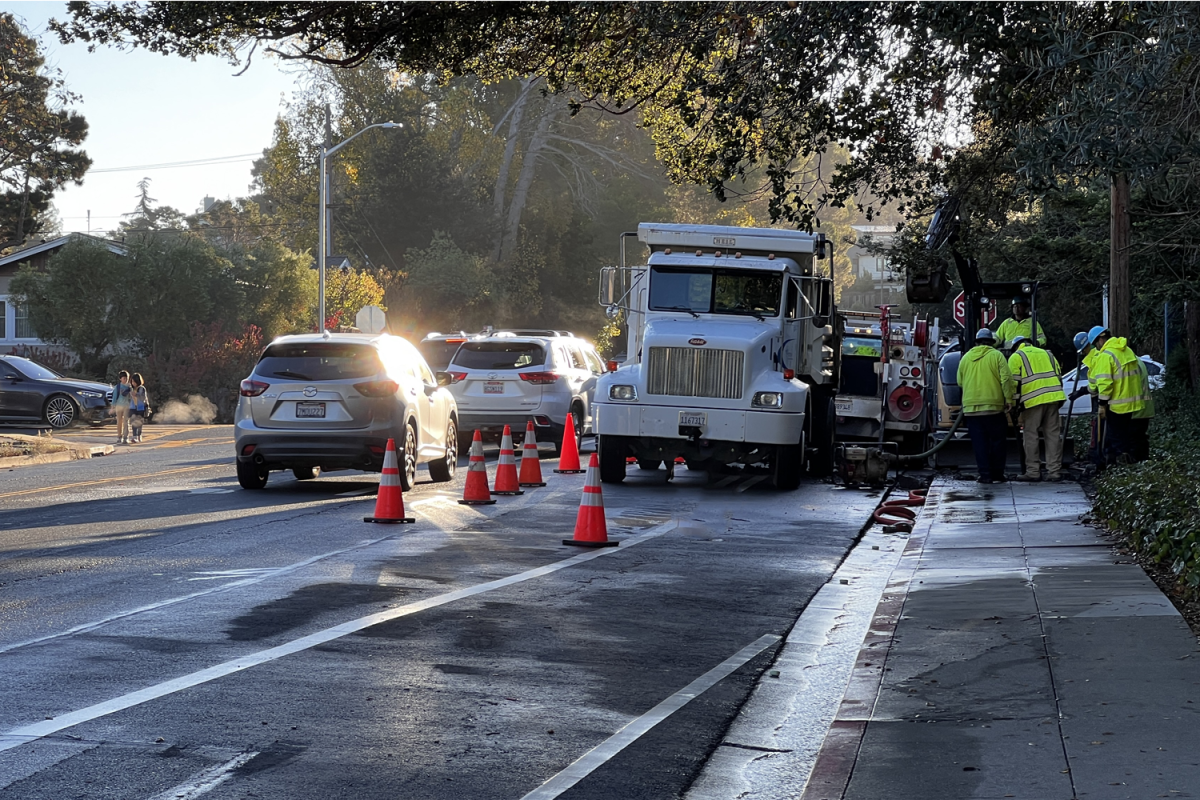 Workers gather to repair the water main break. Trucks and other vehicles arrived in the morning on Alameda de las Pulgas, placing cones to block traffic and prevent interference with the repair.