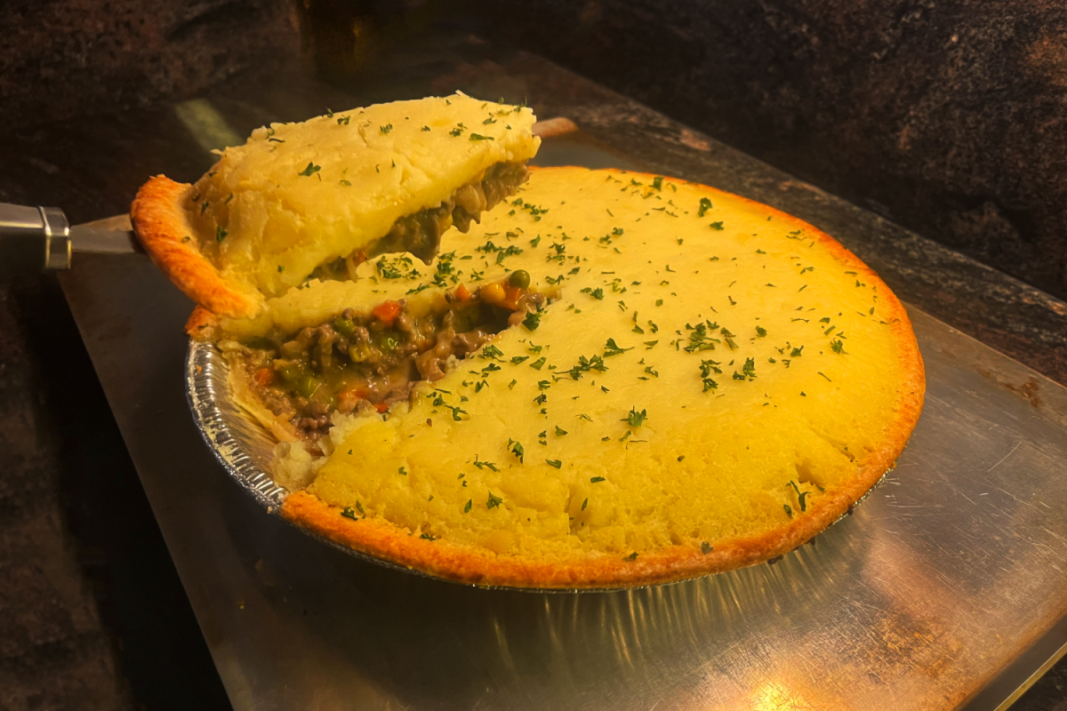 A shepherd’s pie is sliced and prepared for serving. The dish is a popular way to use leftover turkey, gravy, and vegetables after Thanksgiving.