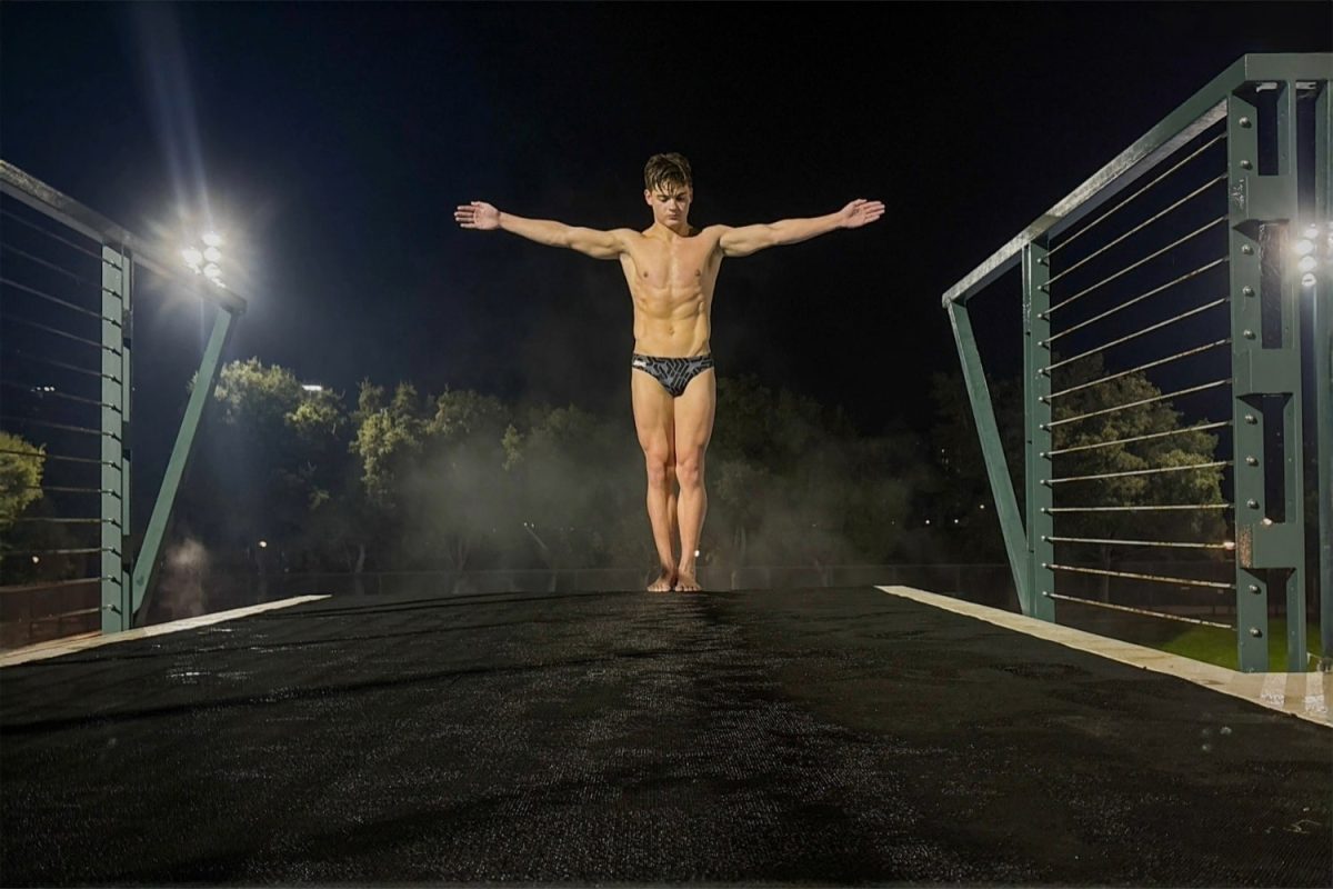 Stanford Diving Club's Johnathan Gullick stands at the edge of a 7.5-meter platform, balancing before a dive. Gullick was focused on gathering his mind to maintain focus and precision. Gullick trains under Oleg Andriyuk, where mental preparation is essential.