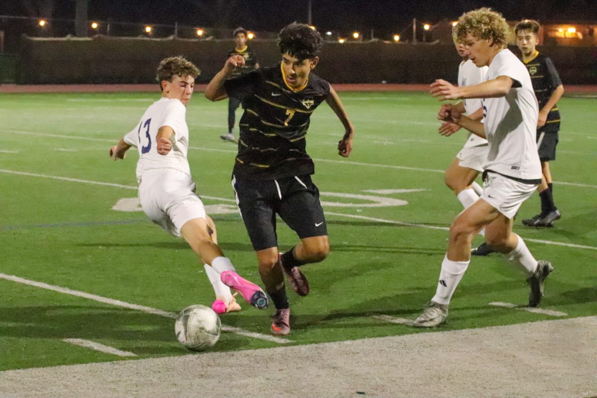 Carlmont player Kian Abrams challenges the Spartan winger and kicks the ball out. Abrams was successful and was able to prevent the Spartan from getting the ball. Both players fell out of bounds ending the play.