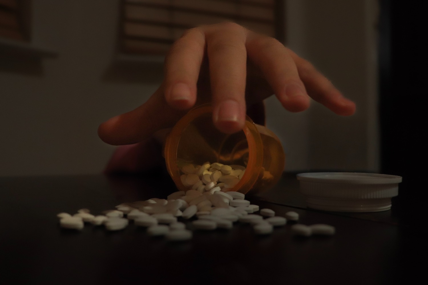 A hand reaches out, looking for relief it will never find. The desperation hides the cost. Academic pressure pushes teens towards dangerous choices.