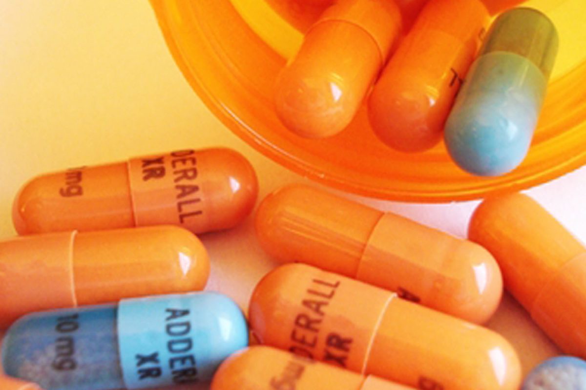 A large amount of Adderall pills spill out of a bottle, demonstrating the dosages Done. patients may have received automatically.