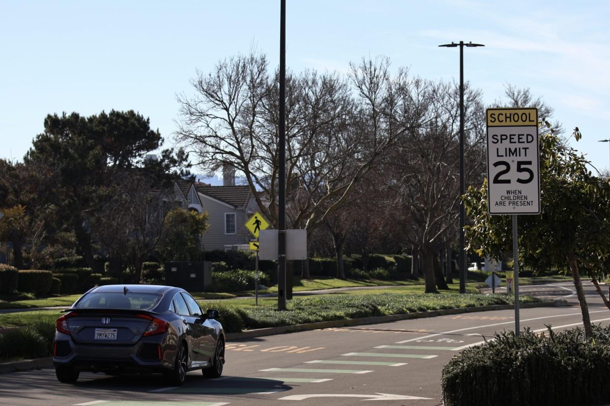 A car speeds past a 25 mph speed limit sign in a school zone. One of California's new traffic laws, Assembly Bill (AB) 382, allows for speed limits to be reduced from 25 mph to 20 mph.