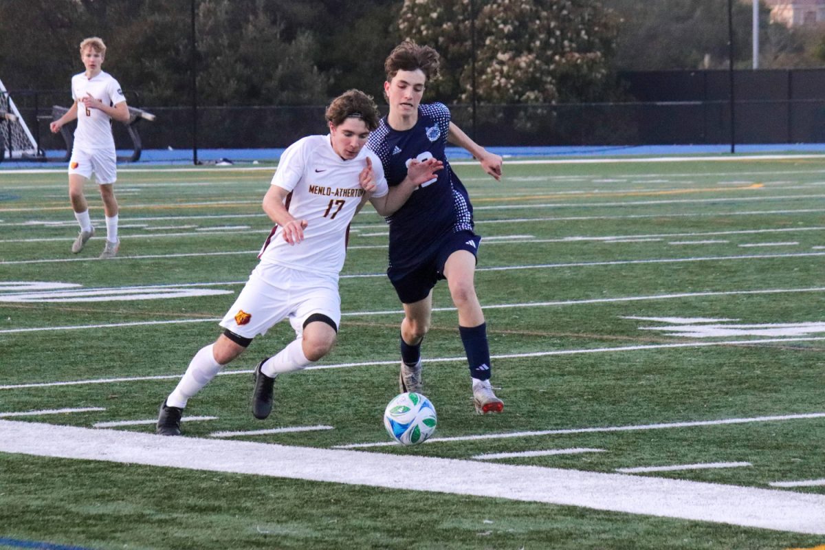 Junior Mark Beilin battles for the ball against Menlo-Atherton senior Pietro Veccheirelli while trying to run down the field. The score was still 0-0, and Carlmont was desperate for a goal. The play was unsuccessful and neither team scored. 