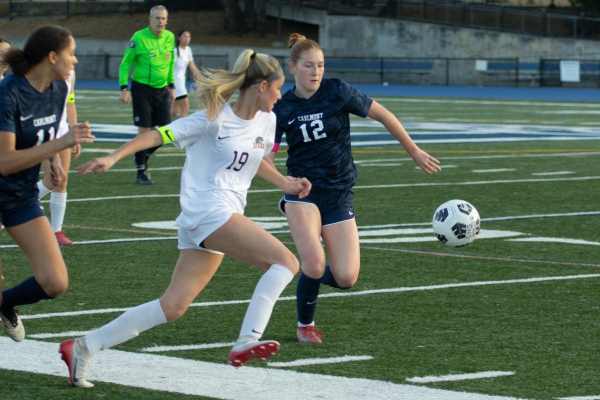 Junior Delaney Kumer races toward the ball with a Burlingame defender close behind. Kumer's effort and composure showcased the Scots' determination to control the pace of play. "Knowing to maintain composure, especially when things get super crowded on the field, is something we can work on," Hazari said.