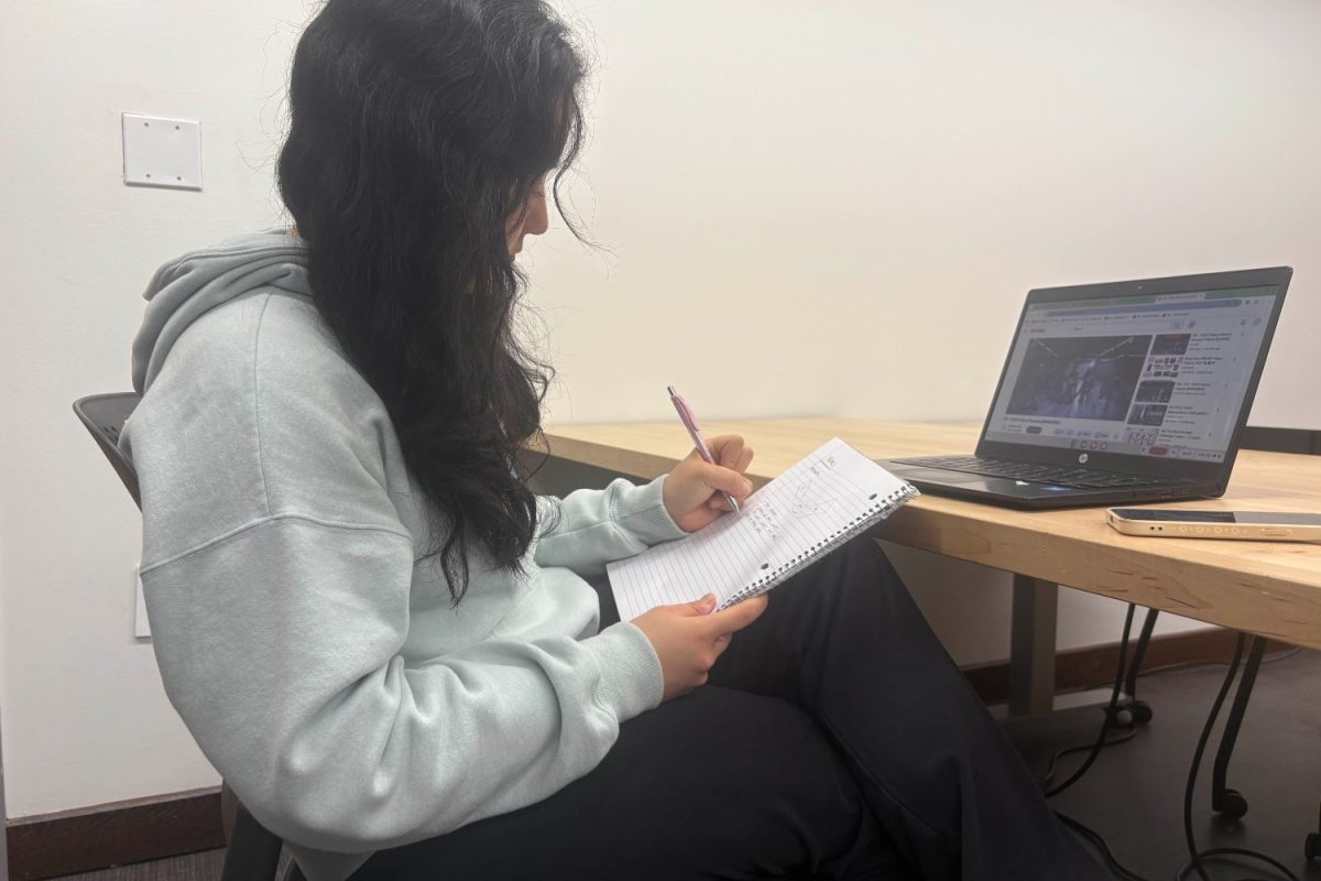 Jessica Sun, a junior and a member of Korean culture group for Heritage Fair is watching a video on her dance while studying for her DECA competition. This reveals the overlap in priorities between the two events. "It was really stressful because I wasn't sure whether or not I could attend both events, or had to sacrifice one," Sun said. 