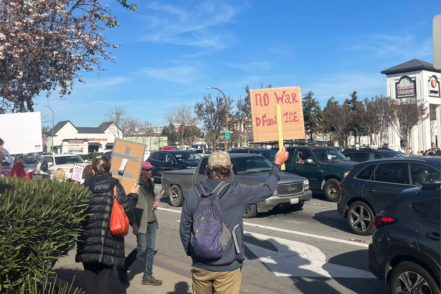A protestor at the "No War on Venezuela" protest on Jan. 17 hoists a sign saying "No War. Defund Ice." The protest included not only anti-war signage but a mixing of related sentiments like this one.