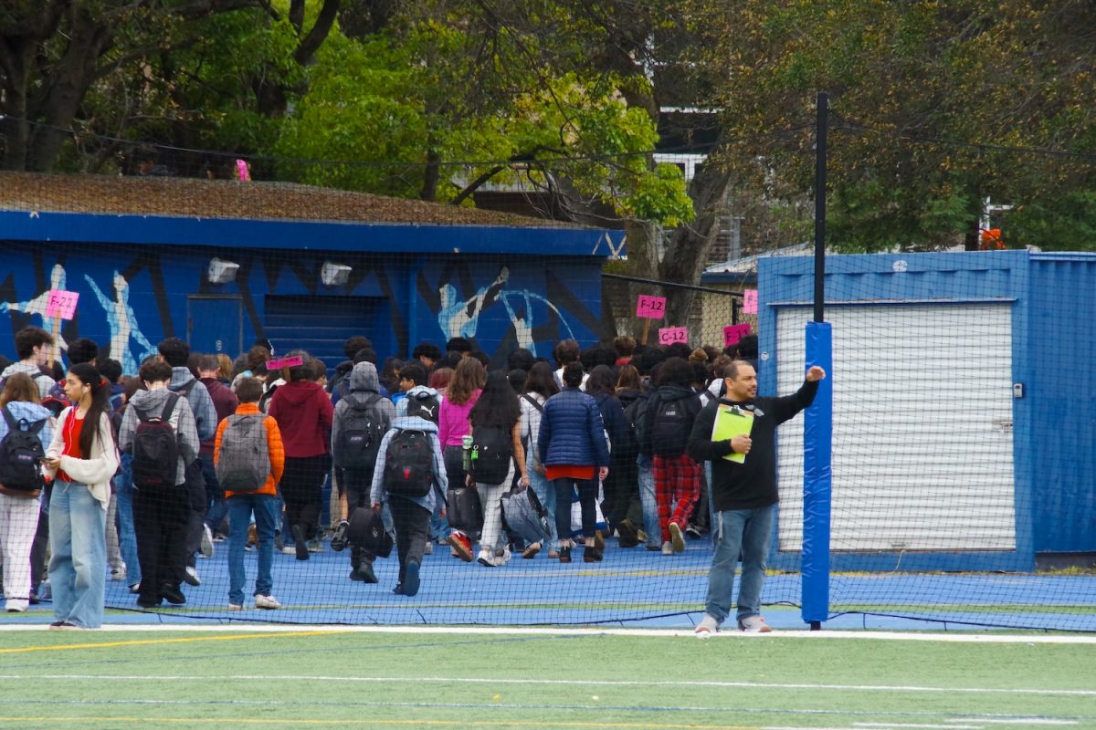 Students evacuate to the football field while following their teachers’ instructions. They stayed on the field for about 15 minutes to ensure their safety before returning to class.