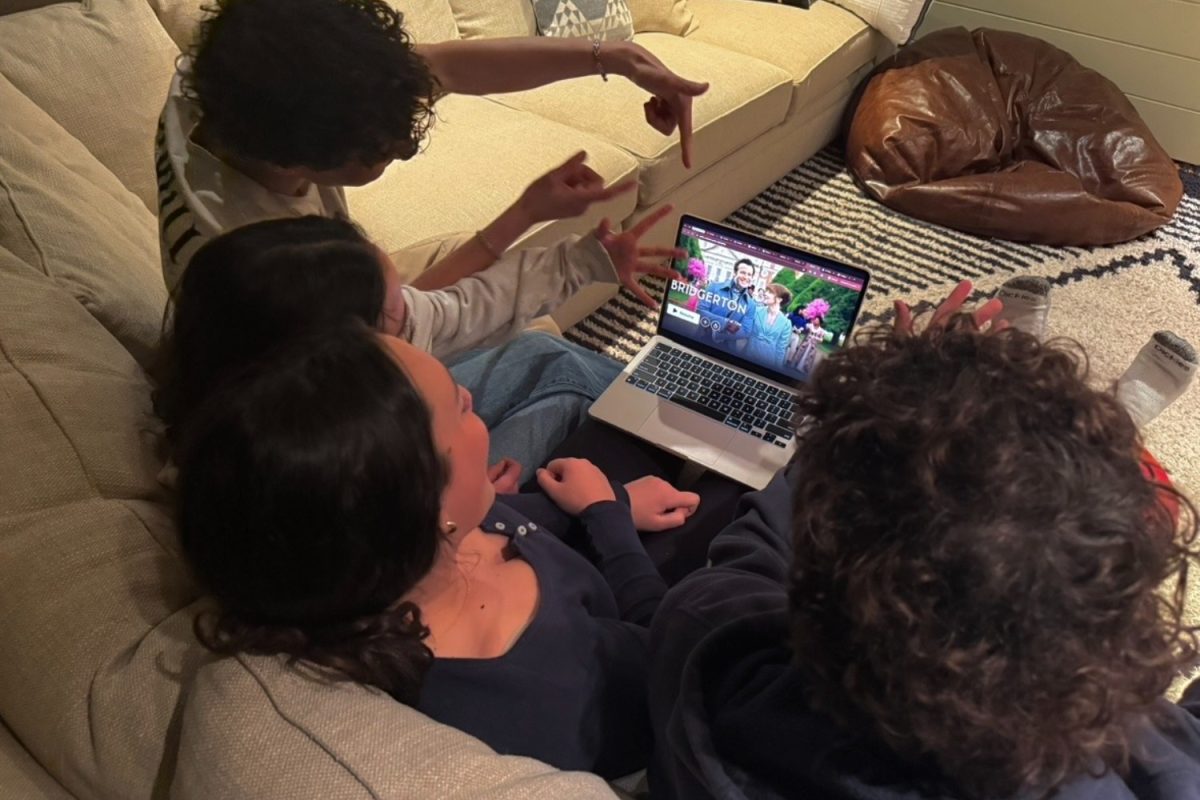 Four teenagers gather around a computer screen, watching the fourth season of "Bridgerton." “I was very excited about the fourth season, and I liked how there was Asian representation. I am always excited to watch 'Bridgerton,'" said Eloise Waight, a sophomore at Carlmont.
