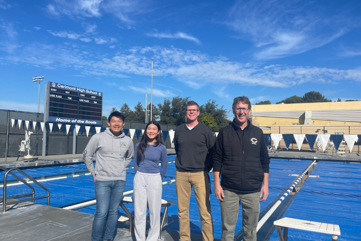 Carlmont juniors and water polo players Asteris Ling and Chloe Ken pose with athletic director Patrick Smith and Administrative Vice Principal Grant Steunenberg in front of the pool. 