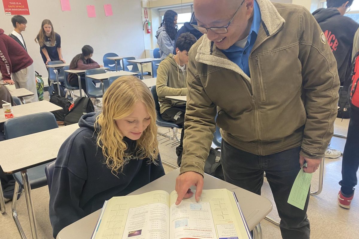 Math teacher Robert Tsuchiyama works one-on-one with a student during his Algebra ll class. This was one of the many math courses he taught during his 37 years at Carlmont. 