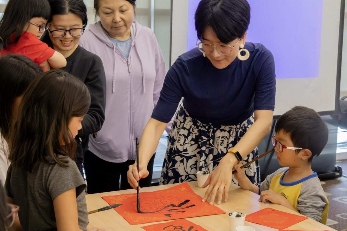 Artist and picture book illustrator Zuzu Gong demonstrates how to write the character "fú", which means blessing, good fortune, and happiness. She completed the character in one continuous, fluid stroke. The paper was later turned upside down, which symbolized that good fortune had "arrived."

