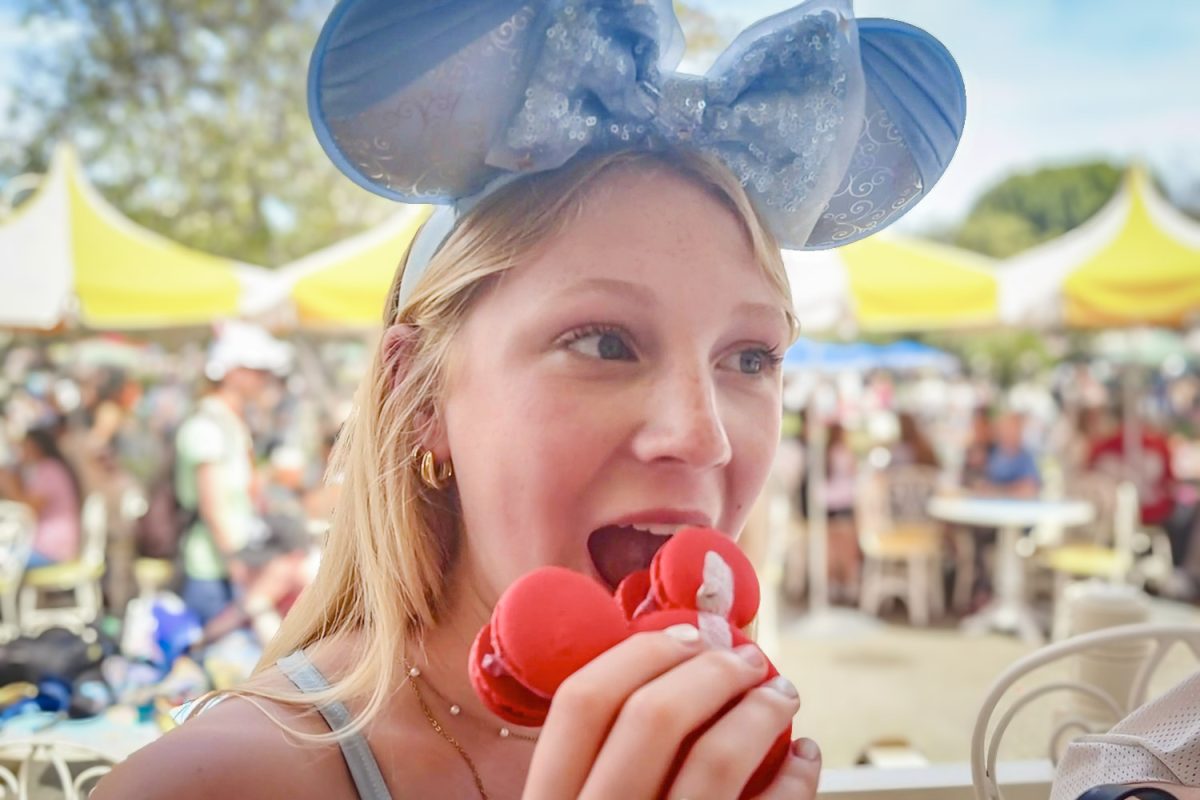 Carlmont sophomore Violet Braley bites into a macaron with the iconic Mickey Mouse shape. Found at the Jolly Holiday Bakery Cafe, the raspberry-flavored macaron contains fresh raspberries inside. "I heard about the Mickey Macaron online, and that one was so good. It had fresh berries and the macaron cookie was a really good texture," Braley said.