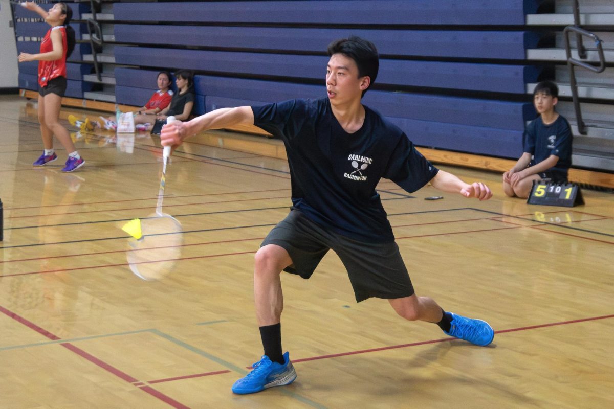 Sophomore Ethan Jeong deflects the birdie during a quick rally. The play shows the timing and precision needed to stay competitive in long rallies. Jeong defeated his opponent 21-13 and 21-11.