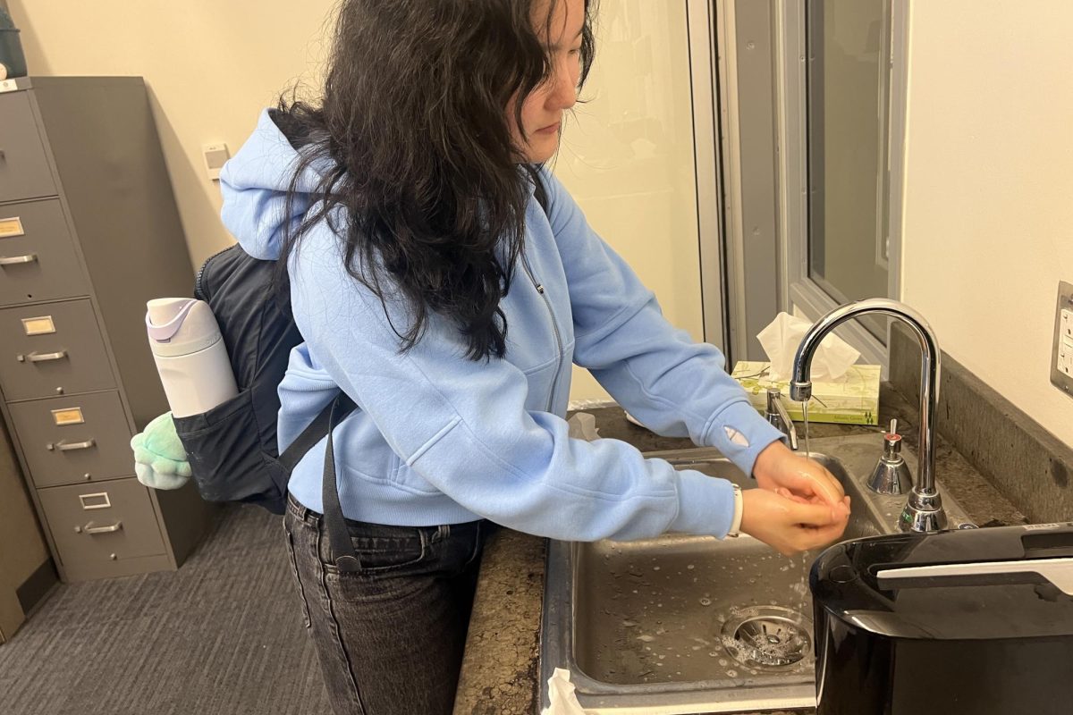 A student washes her hands before class to stay safe and prevent the spread of further illness. School officials had encouraged frequent handwashing and other precautions, especially as cases continued to appear.