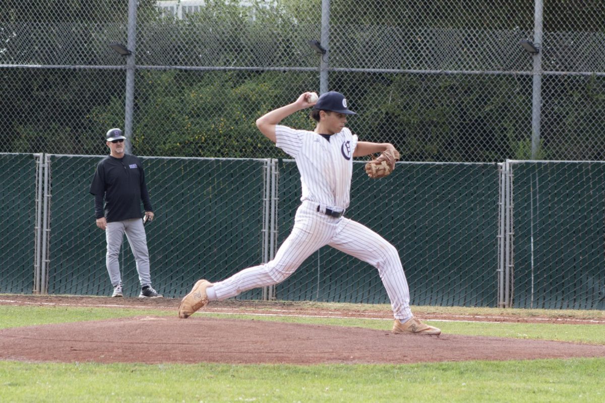 Sophomore Karam Kayali pitches for the Carlmont Scots. He planted his feet and swung his arm for maximum speed and direction. Using his entire body, his throw went all the way to the batter's box. 