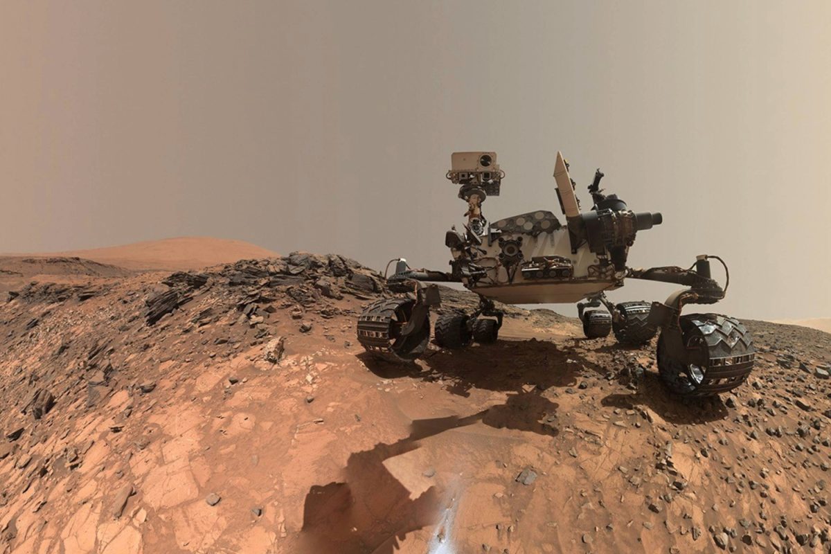 NASA's Mars Curiosity rover navigates a rocky ridge on Mars under a hazy sky. The image was taken by NASA’s Curiosity rover using its onboard navigation cameras during its mission. Since 2021, these rovers have been collecting samples from the Red Planet as a part of a mission to bring them back to Earth, according to The Planetary Society.