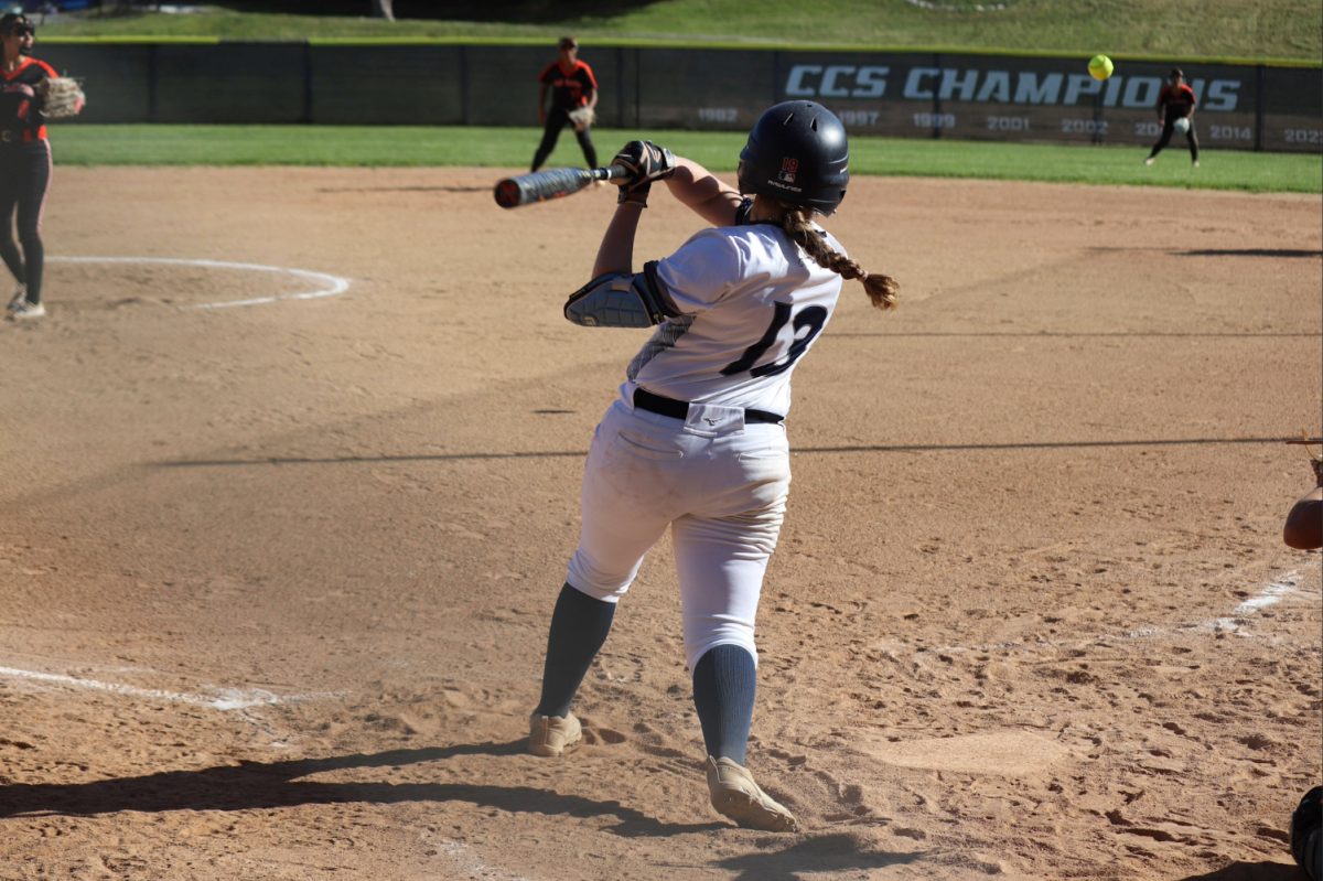Sophomore Chloe Kumli hits the softball. She was able to get to first base safely. Kumli kept her composure and scored Carlmont a point.