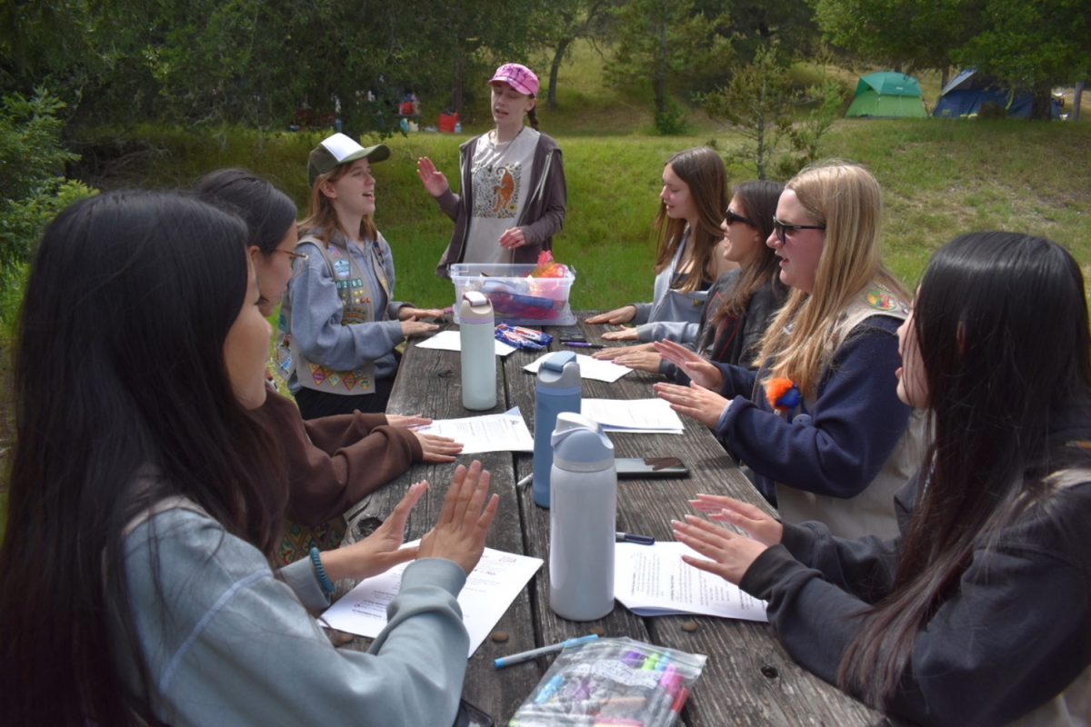 A group of high school Girl Scouts use their afternoon free time to prepare to lead the evening campfire at Rally Day. "I really like meeting new people, like we met a new troop of older Girl Scouts this year," said Adelyn Law, a high school Girl Scout.